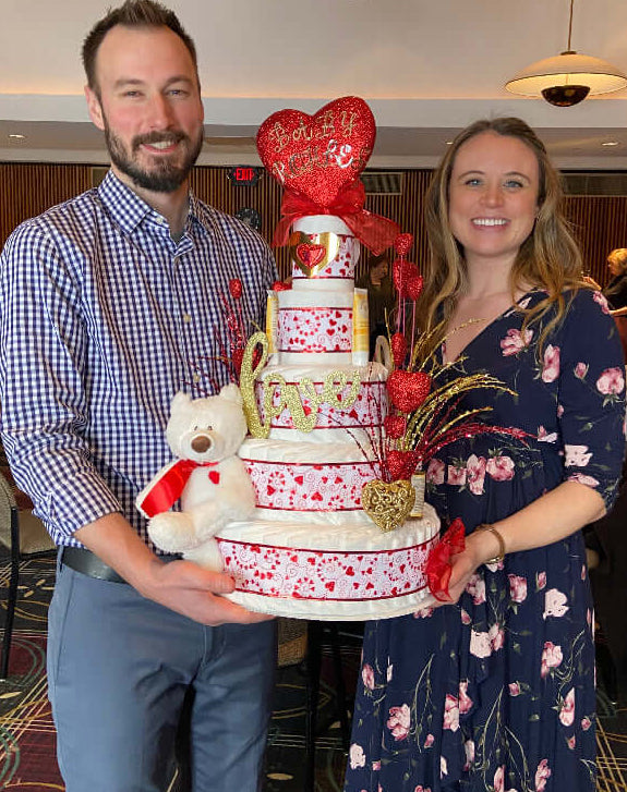 Couple holding a Lil' Baby Cake Diaper Cake