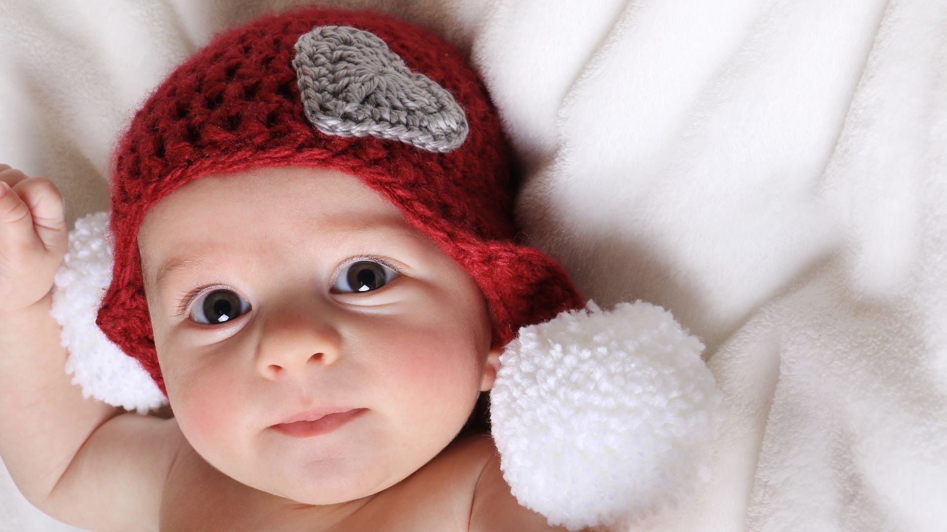 February born baby with heart hat